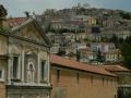 Facciata della Certosa e scorcio del centro storico